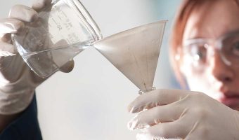 A female scientist working with chemicals in a lab