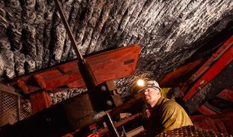 Miners securing resources inside an underground mine.